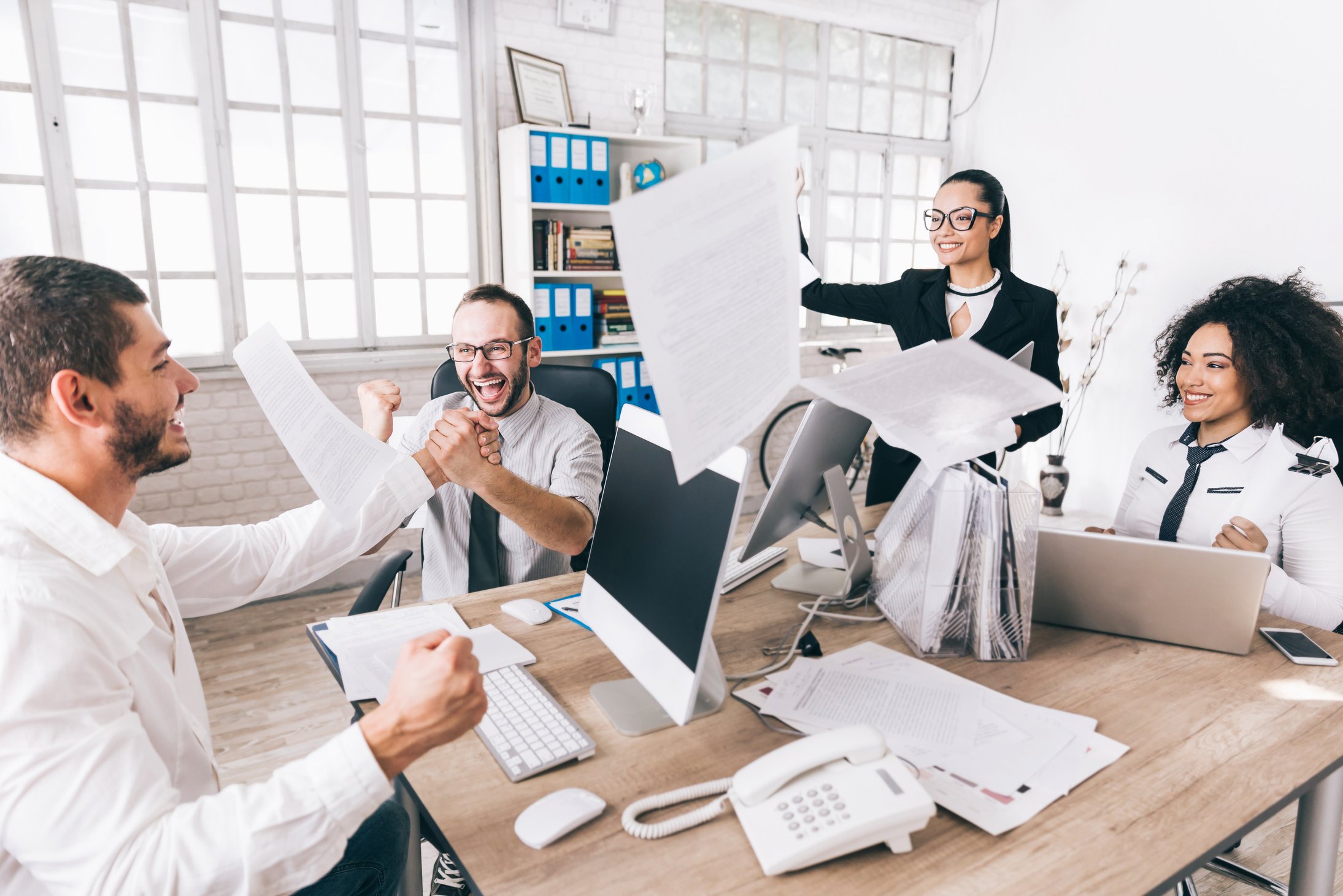 Excited team celebrating at workplace