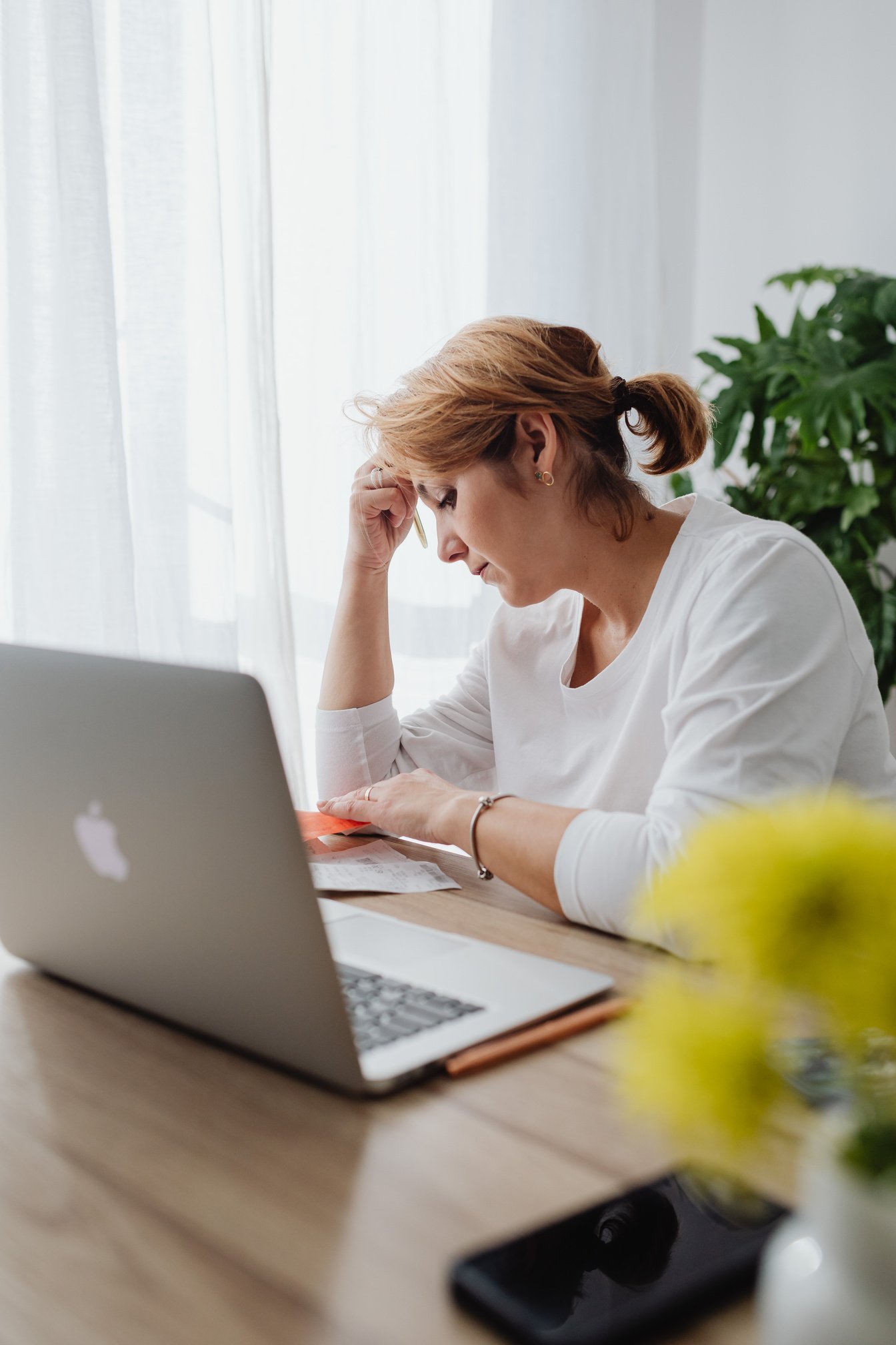 Worried Woman Sitting in an Office in front of her Laptop 